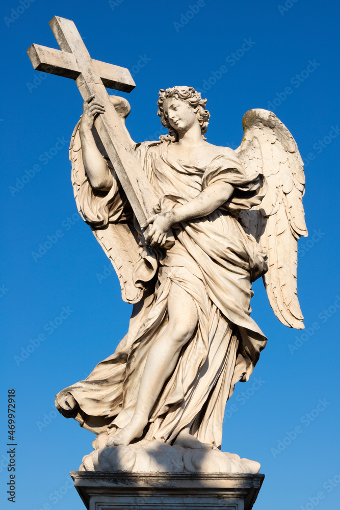 ROME, ITALY - SEPTEMBER 1, 2021: Statue of angel with the Cross in baroque style  from Angel's Bridge by Ercole Ferrata (1610 - 1686).