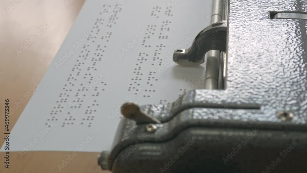 Closeup handheld shot of vintage braille typewriter machine writing