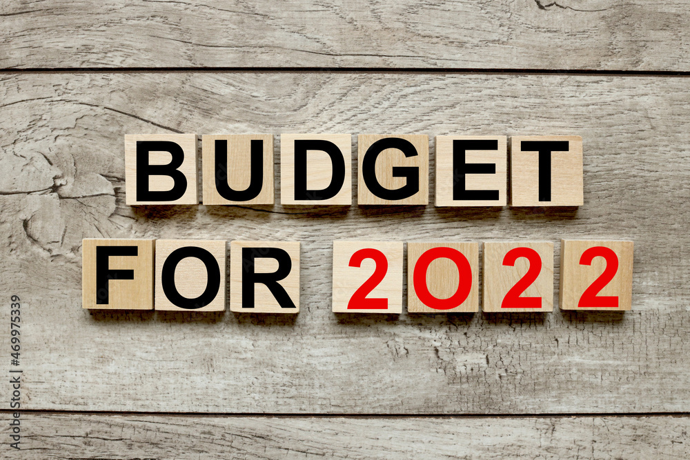 budget for 2022. wooden cubes on a wooden background. three wood blocks budget for 2022. wooden cubes on a wooden background. three wood blocks