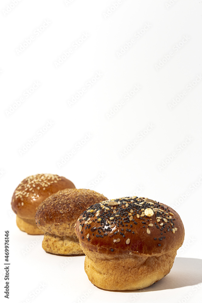 Assortment of small round brioche buns with homemade seeds Assortment of small round brioche buns with homemade seeds