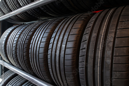 Close up new tyres on shelve in tire shop. Car tires on rack in auto store. © DedOK Studio