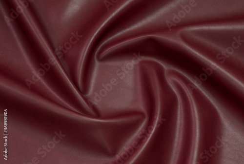 red artificial leather with waves and folds on PVC base