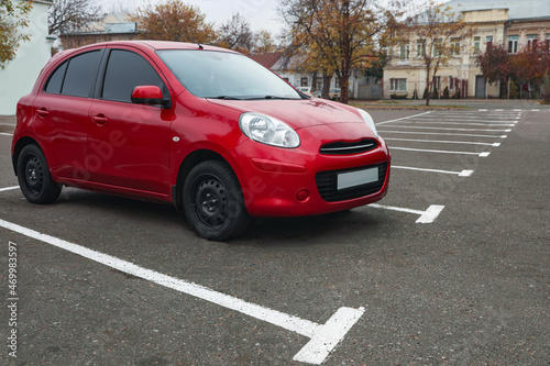 Modern red car on parking lot outdoors