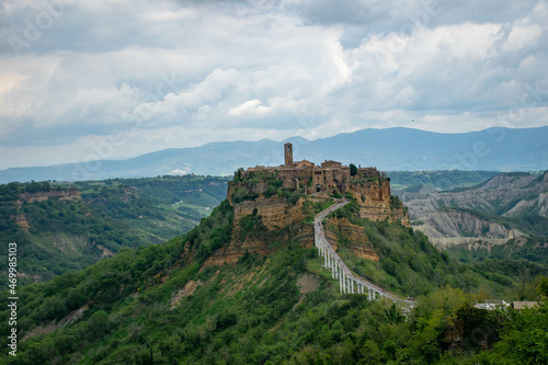 Tuscany  Italy 2019  the old town of Civita on the top of a mountain  a bridge goes to it  against the background of mountains