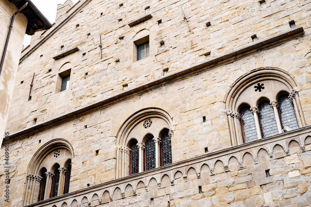 Facade with arched windows of the Palazzo della Ragione. Bergamo, Italy