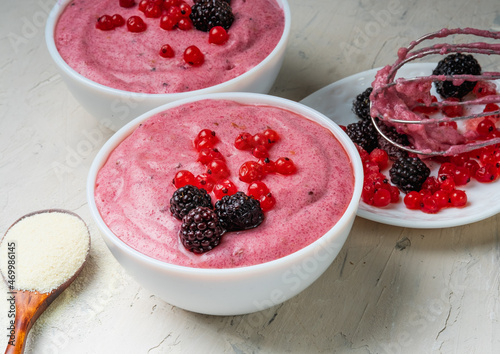 Superfood pudding from semolina with currant berries. Vegan dessert.