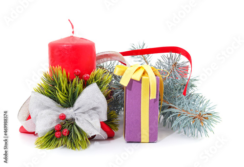 Blue branches of pine with a Christmas candle and gift.