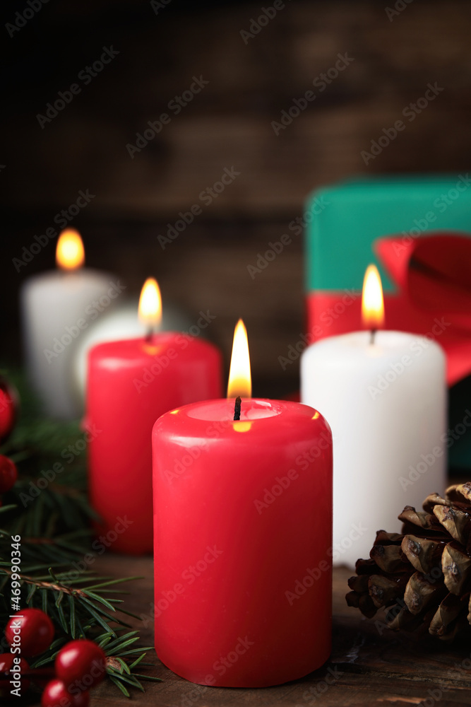Burning candles, fir branches and pine cone on wooden table. Christmas eve Burning candles, fir branches and pine cone on wooden table. Christmas eve