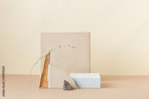 Minimalist monochrome still life composition with natural nature materials: stone, marble, earthy clay and plant dry branch in beige color, copy space, abstract modern art design concept photo