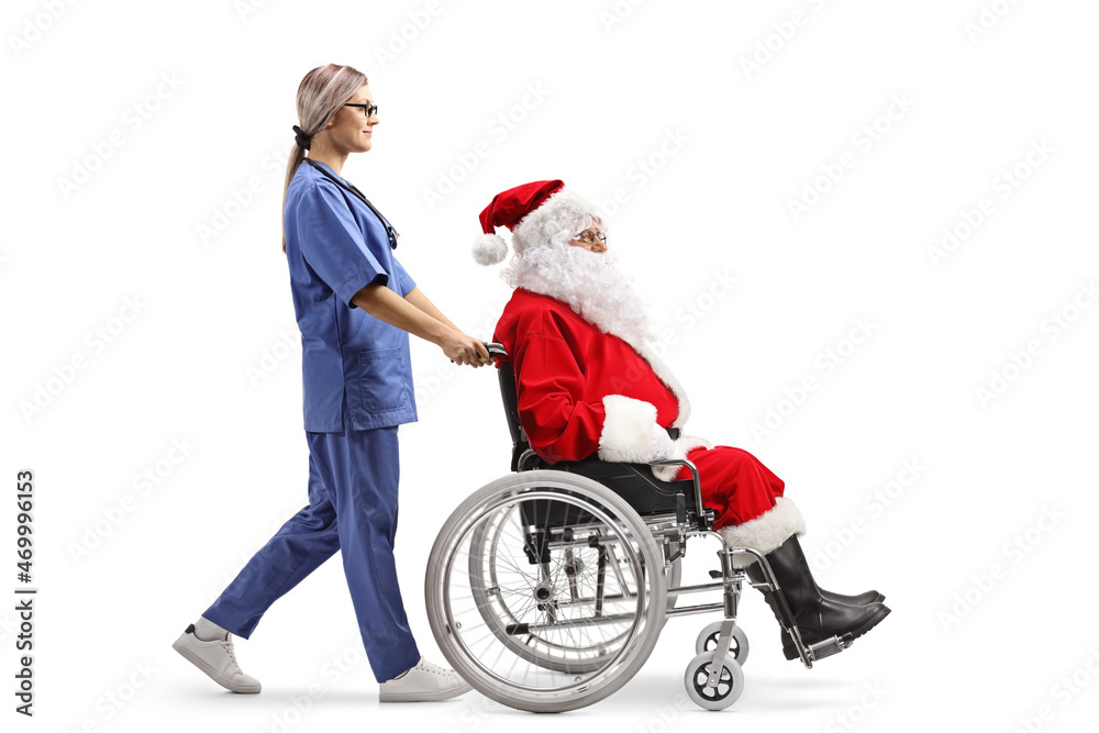 Full length profile shot of a female nurse walking and pushing santa claus in a wheelchair Full length profile shot of a female nurse walking and pushing santa claus in a wheelchair