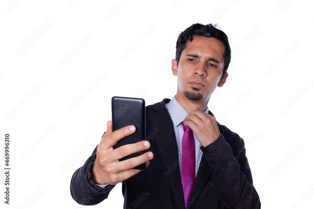 Attractive businessman posing and taking a picture with his cell phone. Young latin adult young man isolated on white background. Attractive businessman posing and taking a picture with his cell phone. Young latin adult young man isolated on white background.