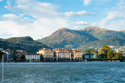 Lugano, Switzerland - October 6th 2021: Skyline of the city with surrounding mountains seen from the lake