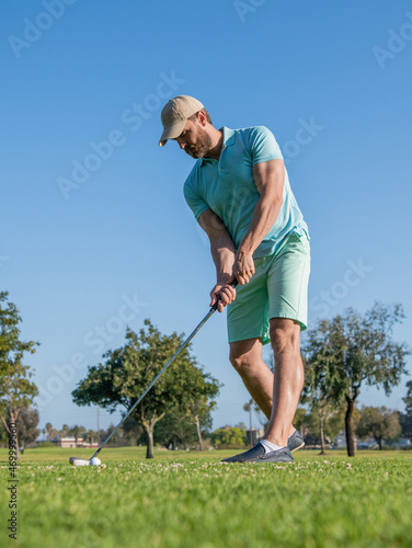 standing man playing golf game on green grass, golfing