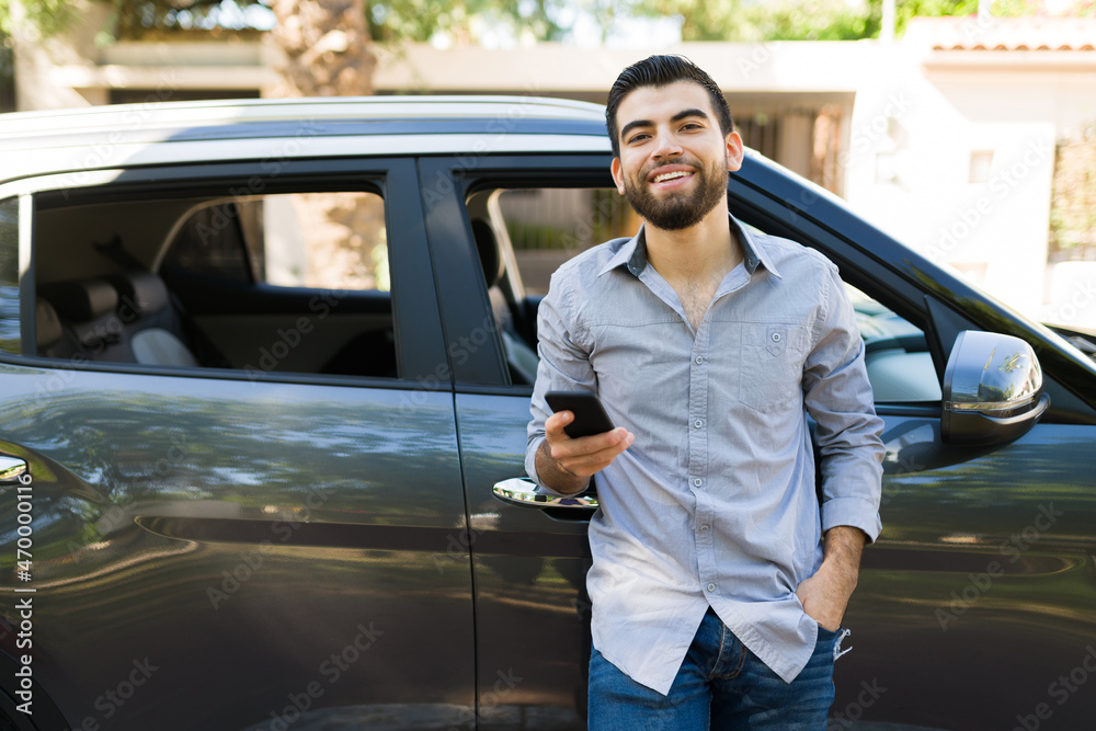 Fototapeta premium Attractive man waiting for friends in his car