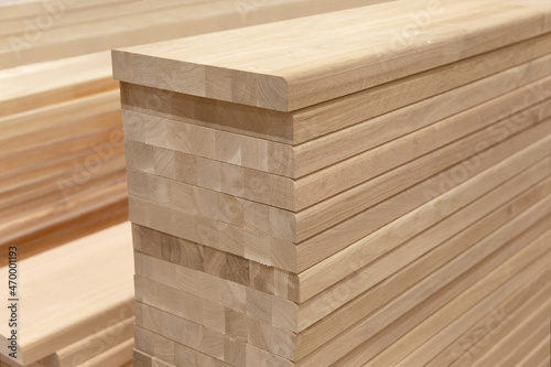 Row of Edge Gluing Boards  Stacks of strong wood planks in a store or on a building site. Natural rough wooden boards boards  lumber  industrial wood