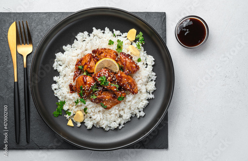 Teriyaki chicken with rice on a gray background. Japanese cuisine.