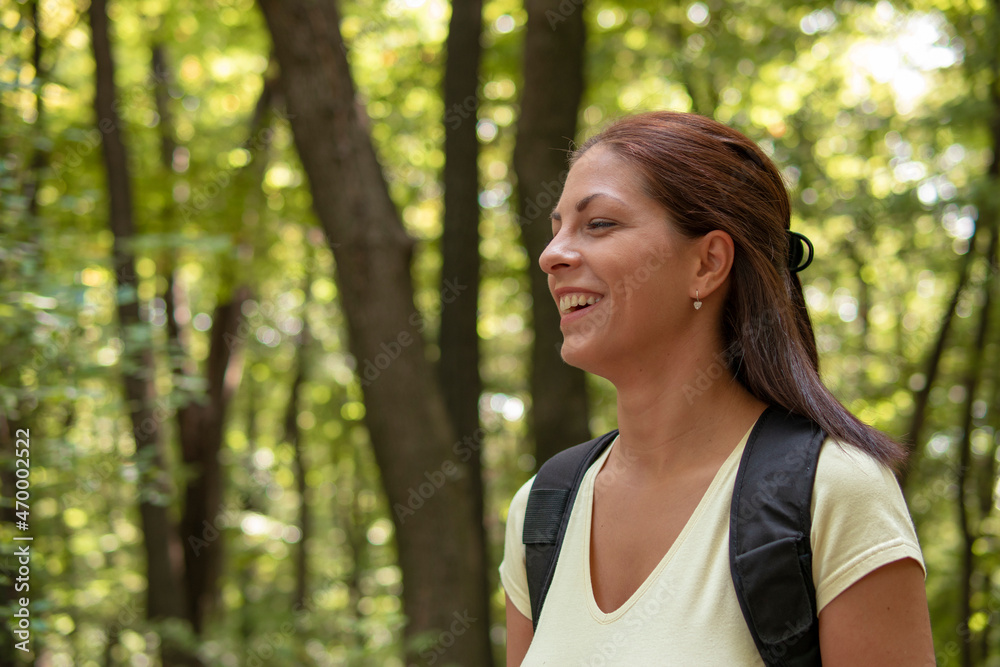 Beautiful woman hiking in the woods in the mountains Beautiful woman hiking in the woods in the mountains