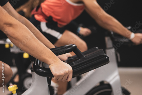 3 young people giving an exercise bike class in a gym. ©  Yistocking