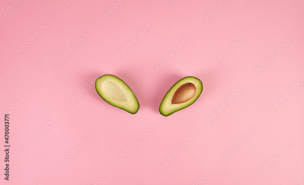 Sliced avocado on a pink background. Sliced avocado on a pink background.