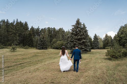 the groom and the bride go to the field, the newlyweds are walking in the woods  © Ринат Куйшин
