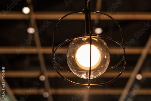 Lanp hanging from the ceiling of a restaurant. photo