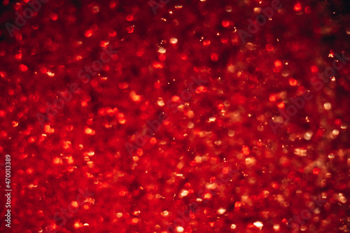 Space abstract background. Christmas backdrop. Texture of red shiny crystals.