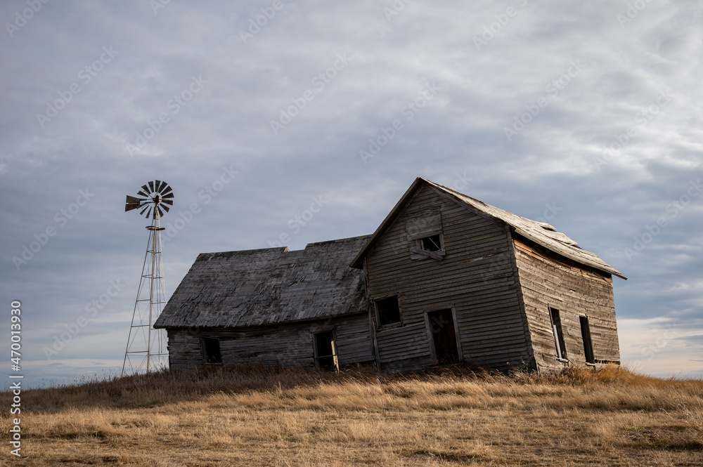 Abandoned farmhouse in rural alberta Canada with cloudy skies Abandoned farmhouse in rural alberta Canada with cloudy skies