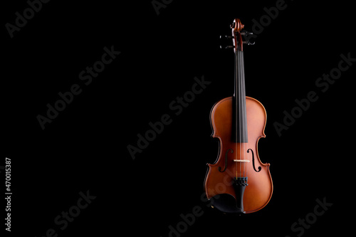 A wooden violin or viola on a black background