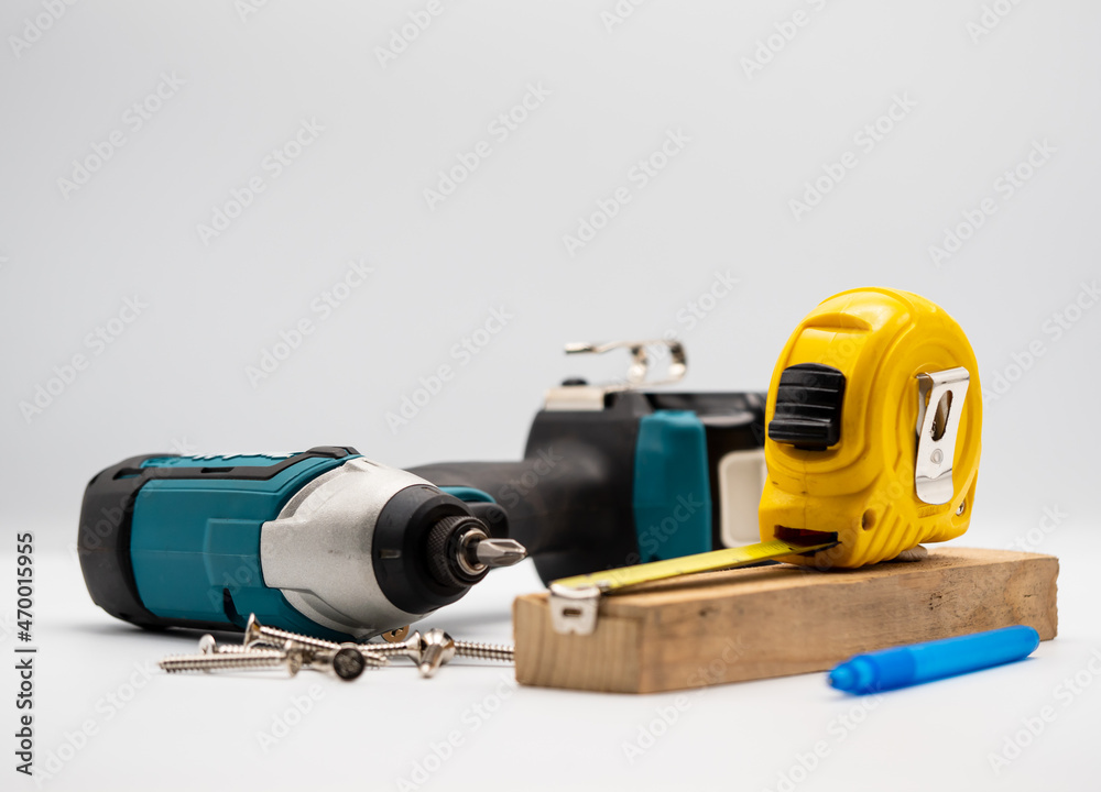 the carpenter workshop's workplace Drills, electric drill, tape measure, ruler with scale, pencil Instruments for the joinery worker the carpenter workshop's workplace Drills, electric drill, tape measure, ruler with scale, pencil Instruments for the joinery worker