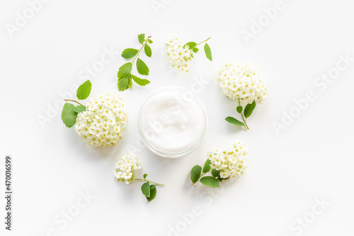 Herbal facial cream cosmetic for skin care with white flowers