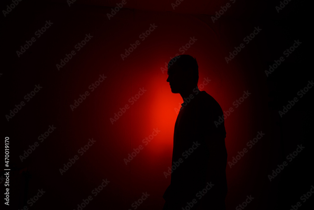 Silhouette of a man on a red background.