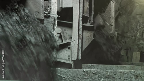 Heavy Machinery and Coal Rocks falling into Buckets at a Rock Face inside an Underground Coal Mine. Close Up.