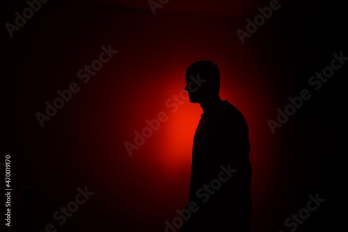Silhouette of a man on a red background.