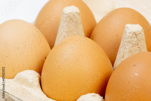 Close-up of brown chicken eggs in an egg box, eco-friendly packaging, homemade chicken eggs from the farm photo