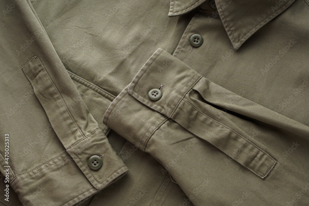 Buttons, pockets, collar, seam, shirt elements. Sewn ready-made shirt made of green natural cotton. Fashion design elements, fashion background Buttons, pockets, collar, seam, shirt elements. Sewn ready-made shirt made of green natural cotton. Fashion design elements, fashion background
