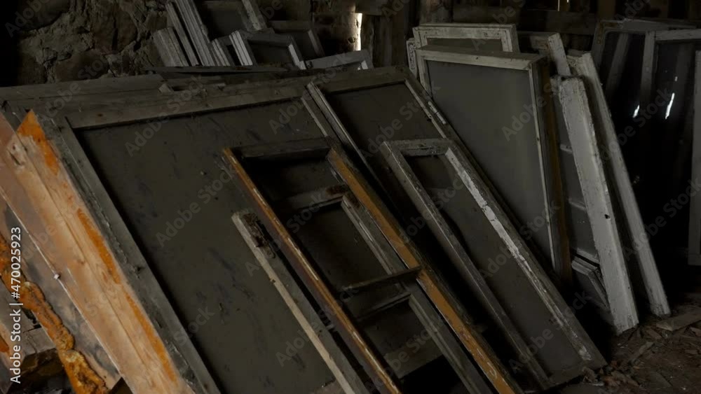 The wooden rails of windows inside the storage room of a dark abandoned house in Estonia The wooden rails of windows inside the storage room of a dark abandoned house in Estonia