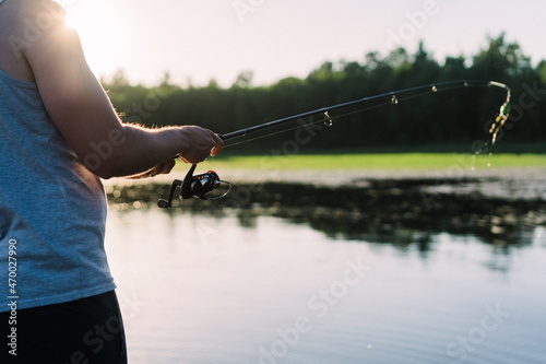 Young adult holding fishing rod