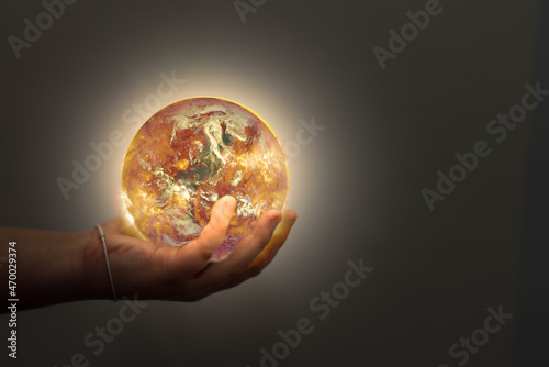Fototapeta Naklejka Na Ścianę i Meble -  child hand hold world on fire in world planet earth environment conservation and protection from global warming(Elements of this Image Furnished by NASA)