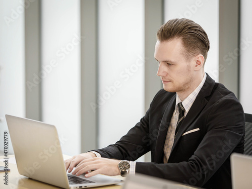 Businessman typing on laptop in office