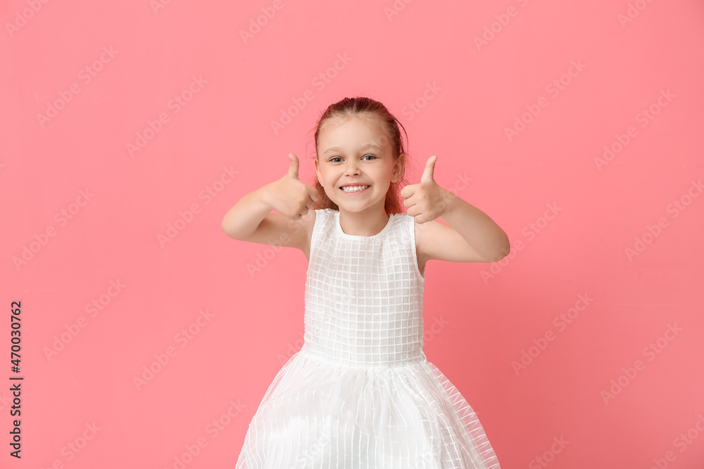 Portrait of pretty little girl showing thumb-up on color background Portrait of pretty little girl showing thumb-up on color background