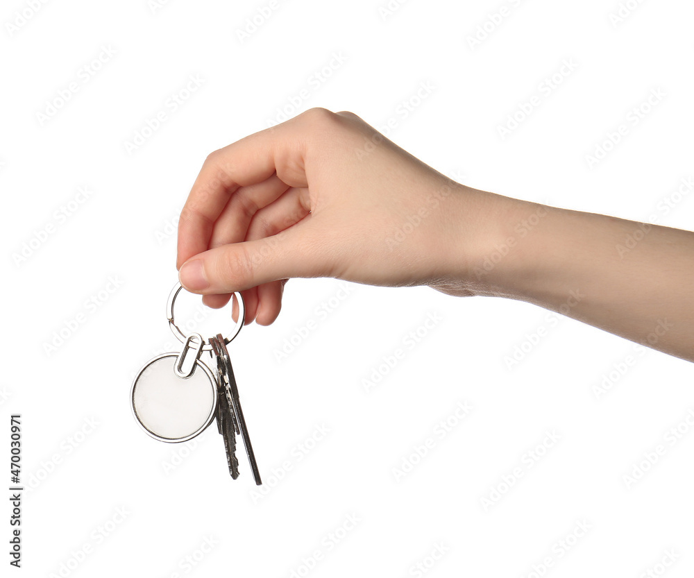 Female hand holding keys with keychain on white background Female hand holding keys with keychain on white background