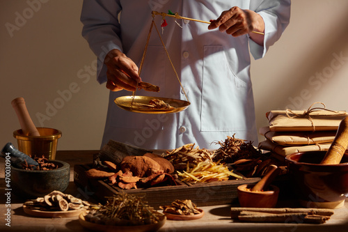 Obraz na plátně Traditional chinese medicine with herb and spices in brown wooden background and