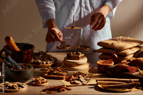 Traditional chinese medicine with herb and spices in brown wooden background and a doctor for advertising , chinese traditional medicine content 