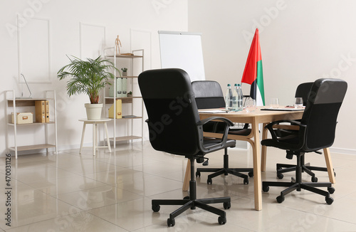 Modern office with UAE flag prepared for business meeting © Pixel-Shot