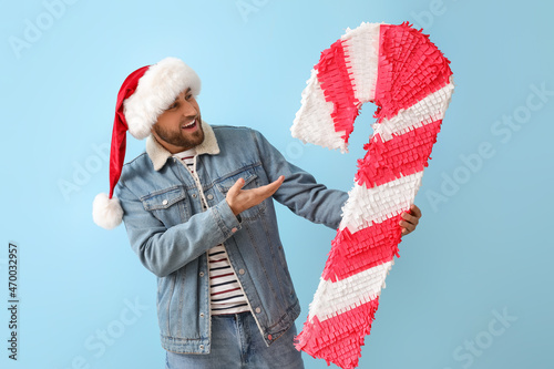 Handsome man in Santa hat w...