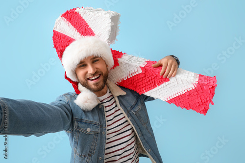Handsome man in Santa hat w...