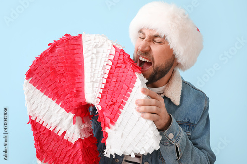 Handsome man in Santa hat w...
