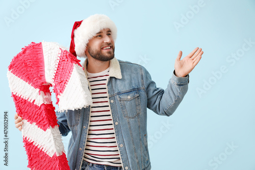 Handsome man in Santa hat w...