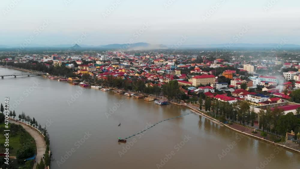 Forward Flying Drone Shot, Showing Kampot Town (City) And The River During Sunset With Mountains in The Background. Kampot, Cambodia Forward Flying Drone Shot, Showing Kampot Town (City) And The River During Sunset With Mountains in The Background. Kampot, Cambodia