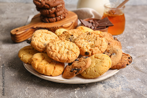 Plate with tasty homemade cookies on grey background